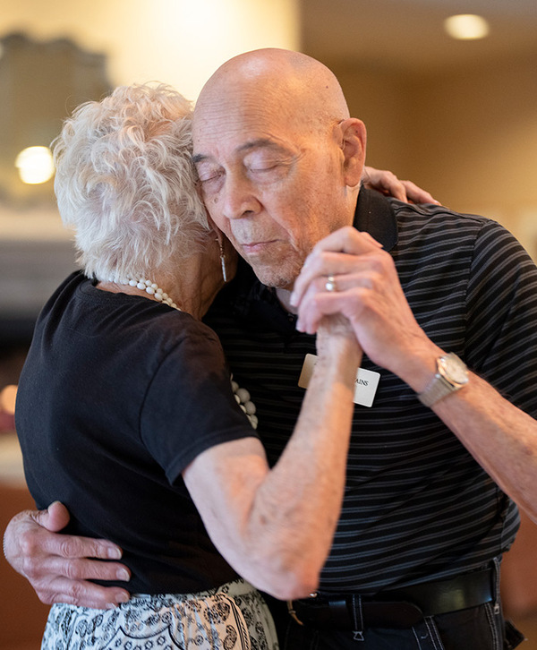 Accordion image Residents are slow dancing together.