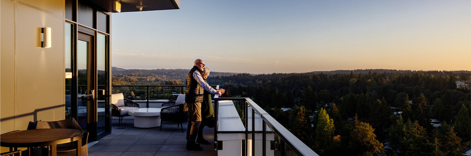 Two people looking out over the balcony. Two people looking out over the balcony.