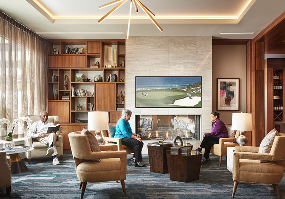 People sitting in a living room area. People sitting in a living room area.