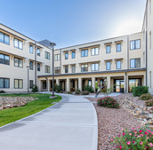 Exterior walking path in front of The Watermark at Cherry Hills, a senior living community in Albuquerque, NM.