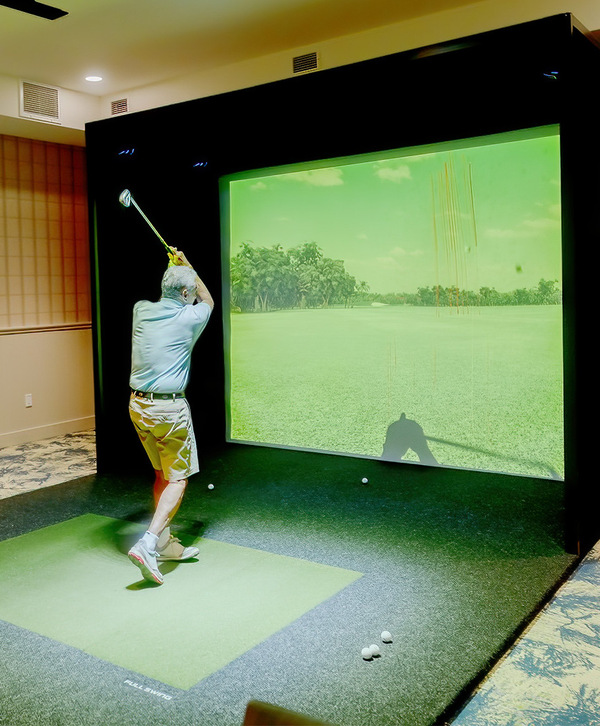 A person using a golf simulator.