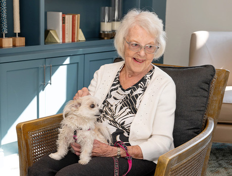 A person sitting with their dog.
