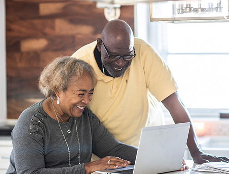 A couple on the computer at home.
