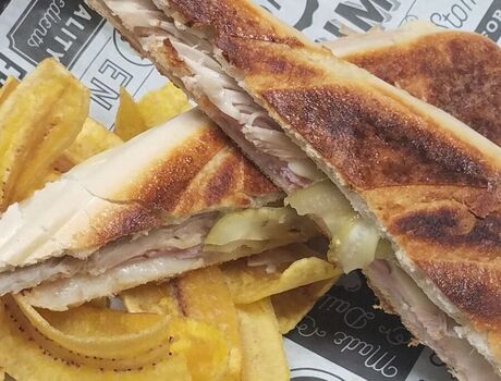 A Cuban Sandwich with plantain chips.