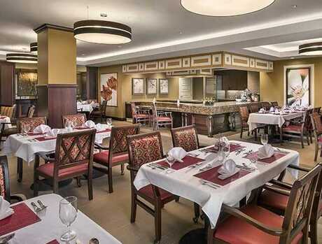 A dining room with tables set for service.