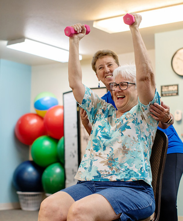 A person in a fitness training session, lifting weights.
