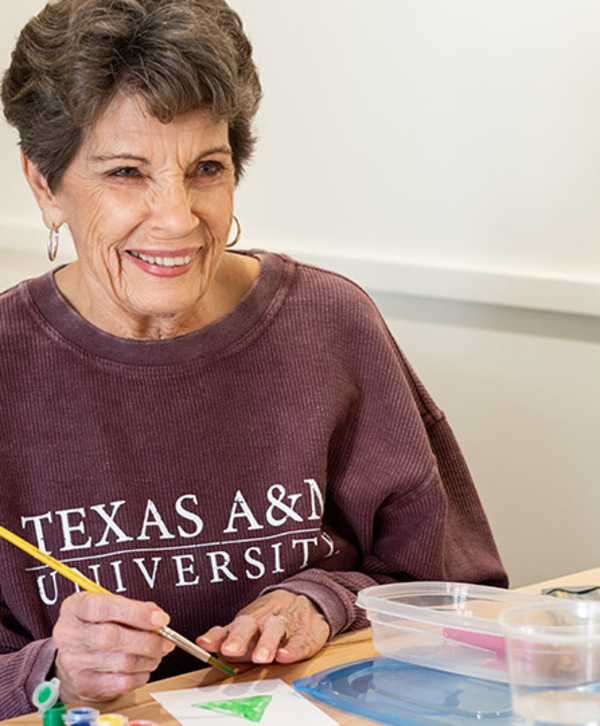 A resident in a painting class. A resident in a painting class.