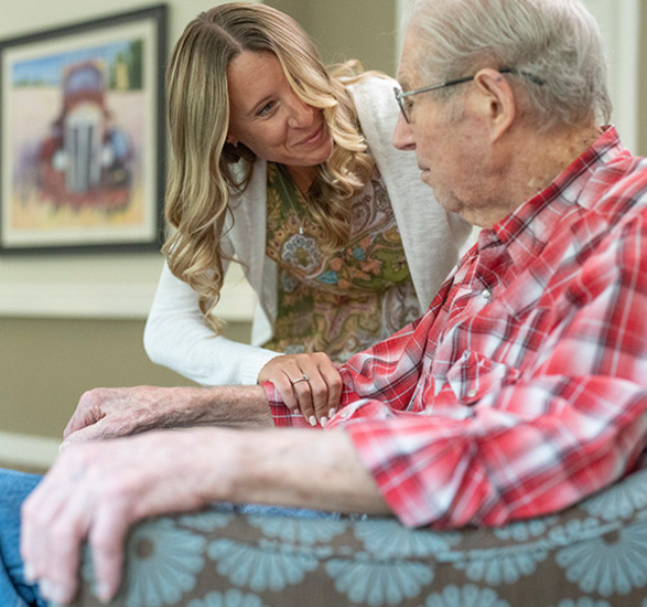 A resident is talking with their caregiver.