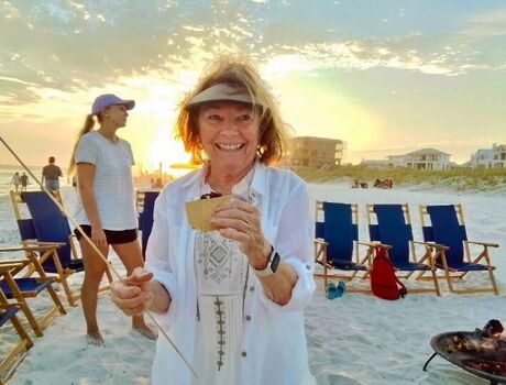 A lady is at a beach with friends. 