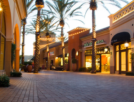 An outdoor mall with store fronts.