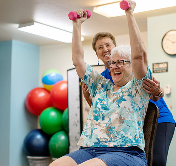 A person in a fitness training session, lifting weights.