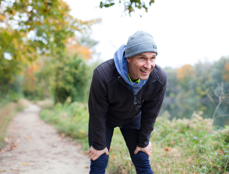 A person resting on a walking trail.