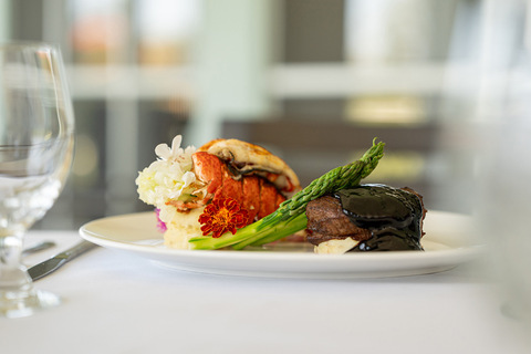 Steak and lobster on a plate.