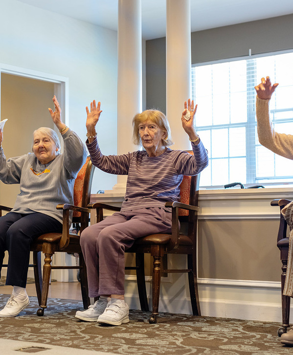 Accordion image People sitting in chairs doing exercise.