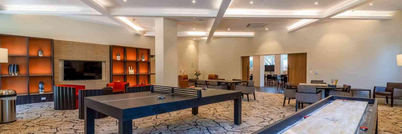 Game room with table tennis and shuffle board. Game room with table tennis and shuffle board.