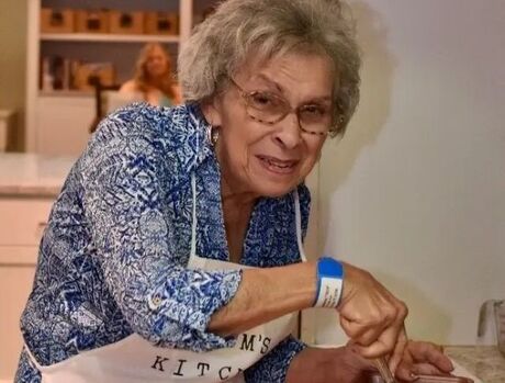 Resident mixing ingredients in bowl.