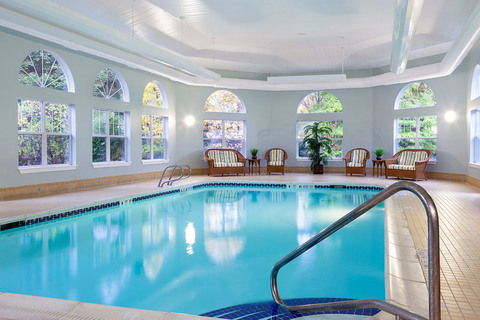 Indoor pool with seating area.