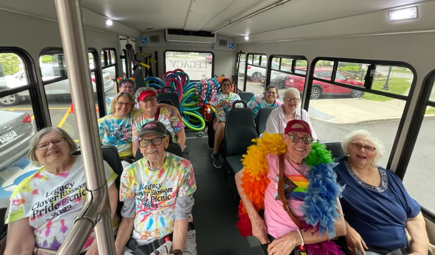 Residents on bus in pride clothing