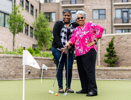 Two people golfing.