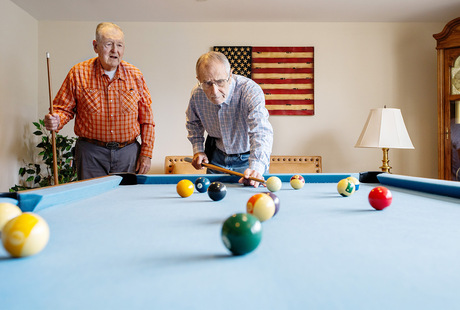 Two people playing pool.