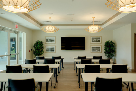 A classroom with tables and chairs.
