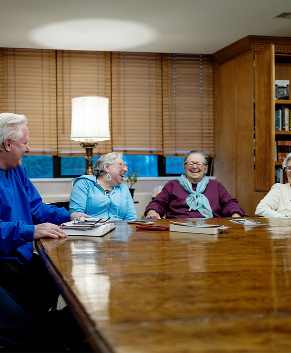 People at a table in the library.