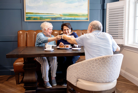 Three people having coffee at The Watermark at Vistawilla senior living community in Winter Springs, FL.