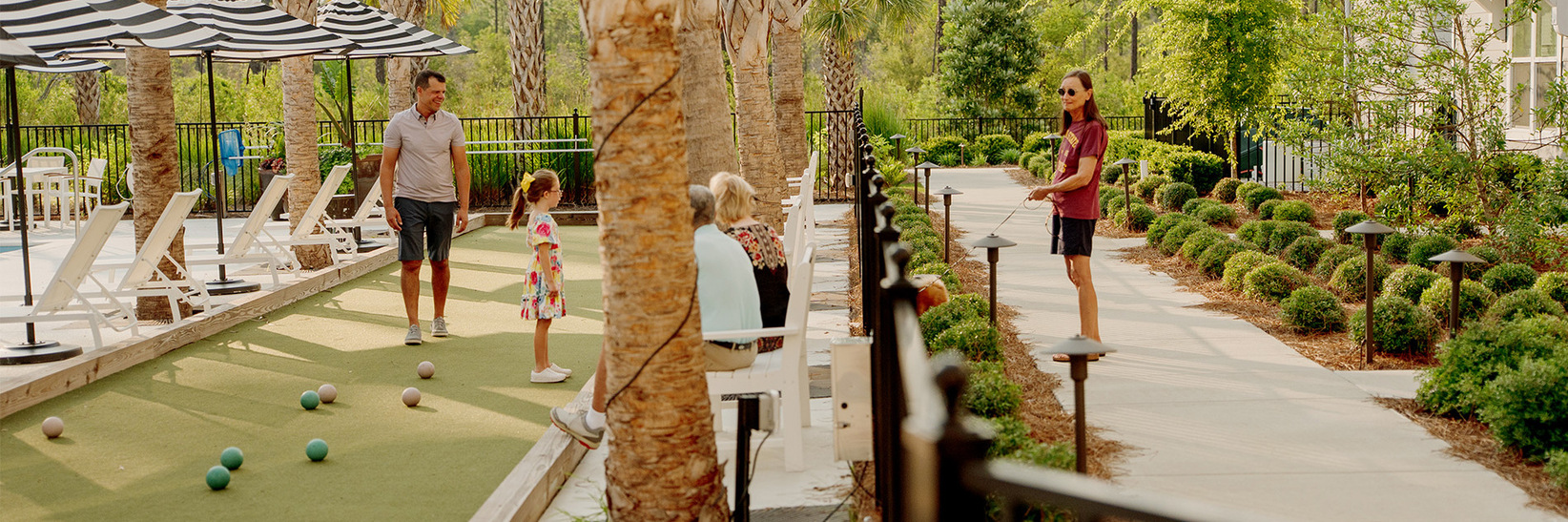 People on the bocce ball court at Watersounds Retirement Living community are talking.