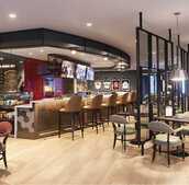 A bar with tables and chairs.