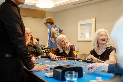 A group of people playing cards.