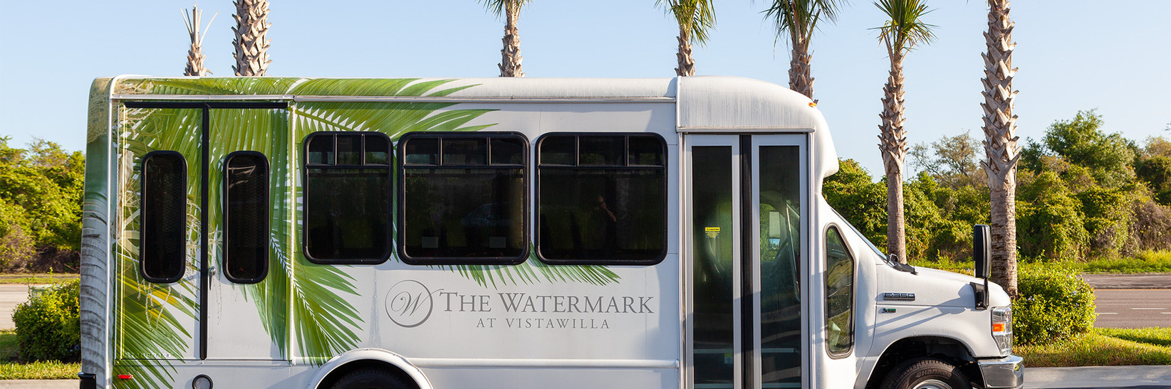 A transportation bus parked outside of community. A transportation bus parked outside of community.