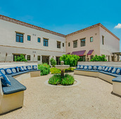 The Hacienda at the River exterior building and courtyard. 