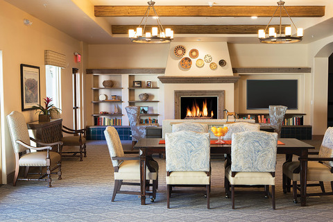 Seating area with sofas, chairs, and tables.