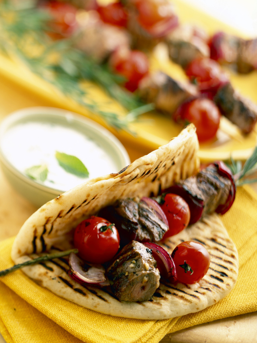 Grilled souvlaki in pita with tomatos
