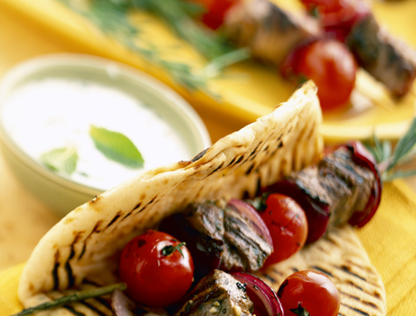 Grilled souvlaki in pita with tomatos