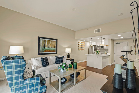Furnished living room space with sofa, table, and seating area.