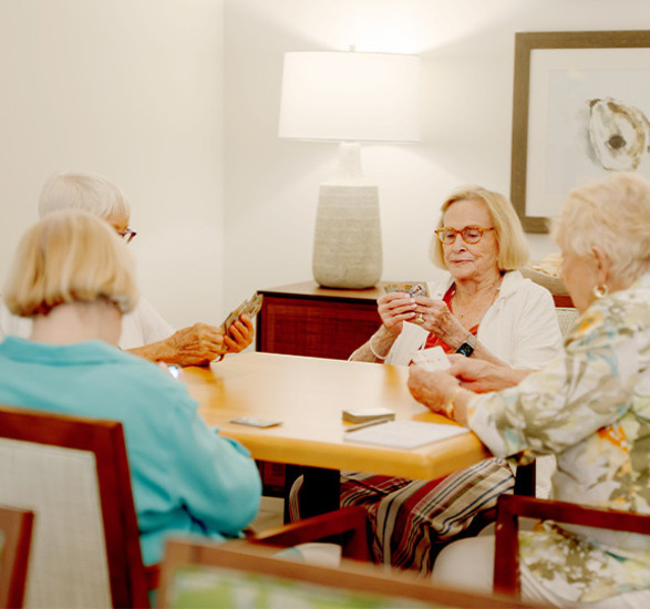 A group of people playing cards.