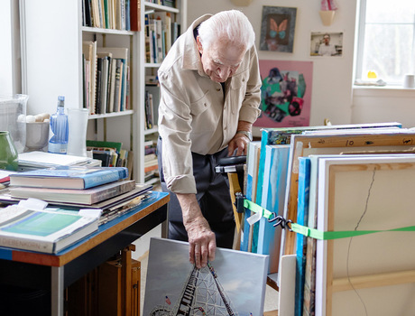 A person pulling out a painting.