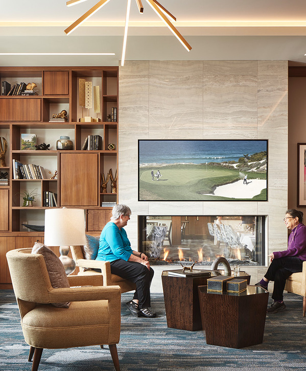 People enjoying a common living room area. People enjoying a common living room area.