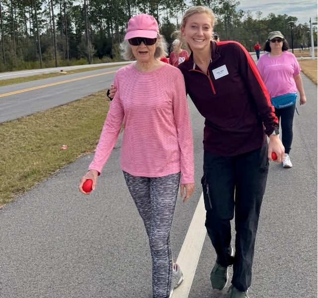 Lynn, a resident, is walking with an associate.