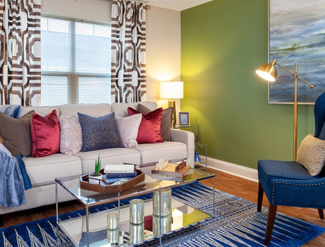 Furnished living room space with sofa, table, and seating area.