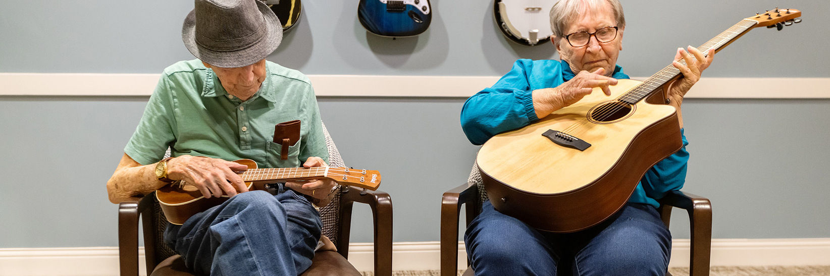 Two people playing guitars.