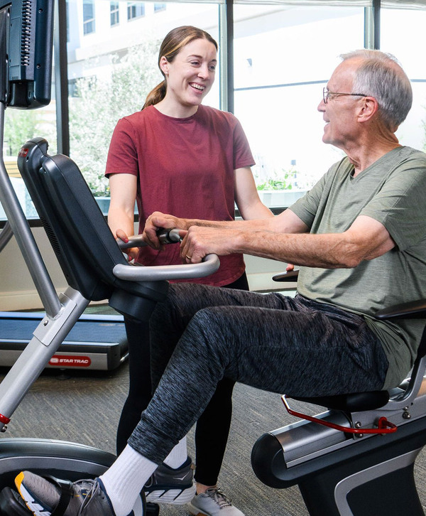 Accordion image A resident on a fitness machine in the fitness area.