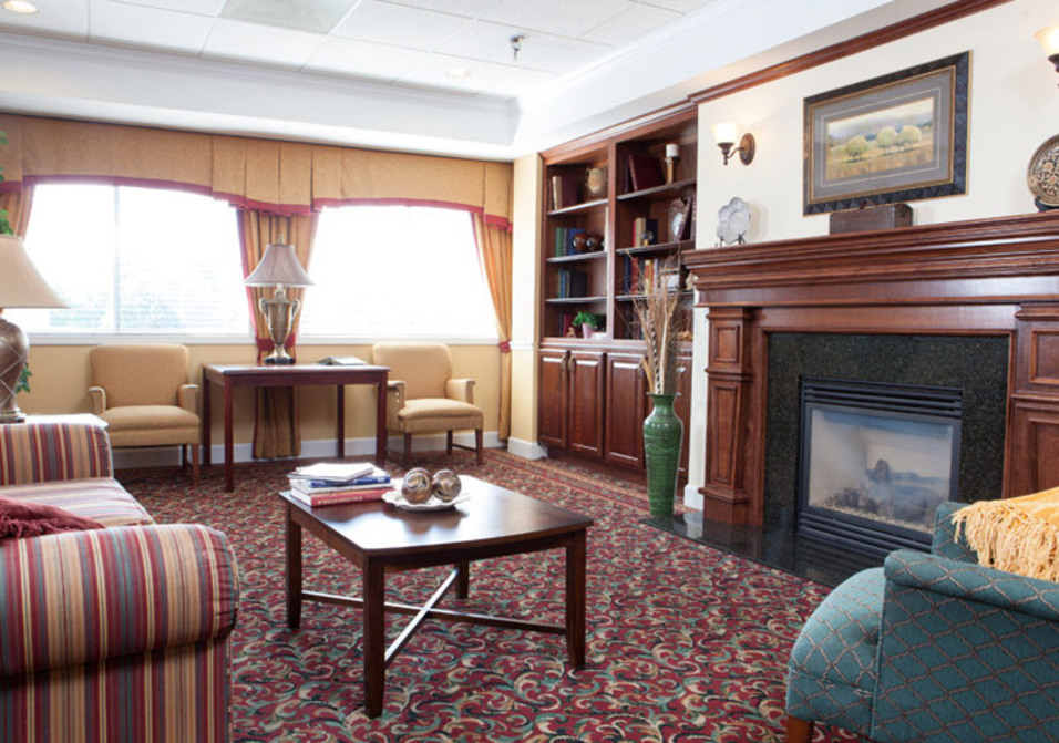 Furnished seating area with a fireplace. Furnished seating area with a fireplace.