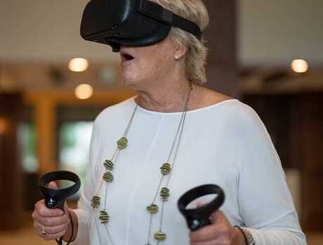 A resident is using the Engage VR set.