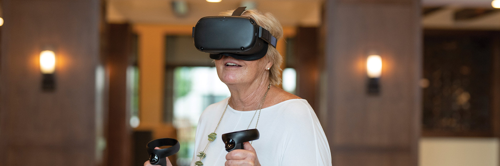 A resident is using the Engage VR set.