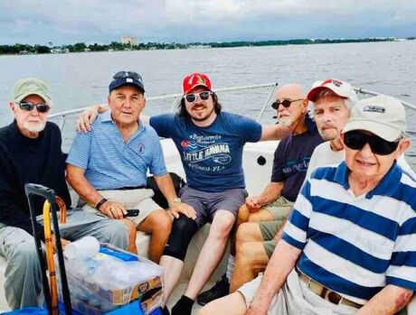A group of male residents on a boat together.