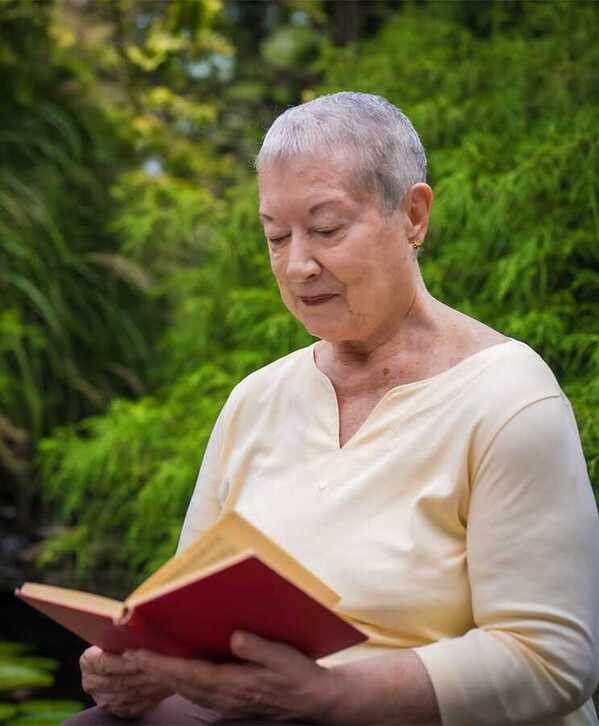 Mind A resident is reading a book outside.