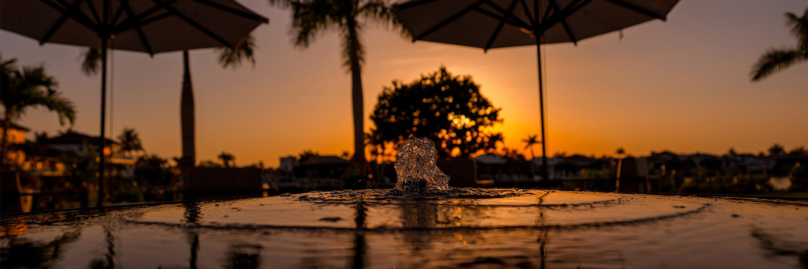 A water fountain with a sunset. A water fountain with a sunset.