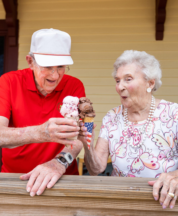 Accordion image Two residents enjoying cones of ice cream outside.